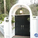 Custom entrance gate with redwood arbor and cedar doors, designed and built in house.